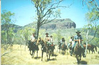 picture of horse riders in australian bush with Mt Mulligan (woothakata) in the background